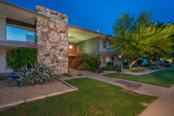Aura at Midtown apartments with classic mid century stone construction and lush landscaping.