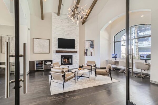Mandarina apartments lobby with leather arm chairs, computer desks, fireplace, and TV.