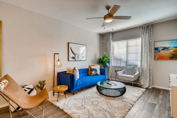 Mandarina apartment living room with bright furniture and eclectic decor.