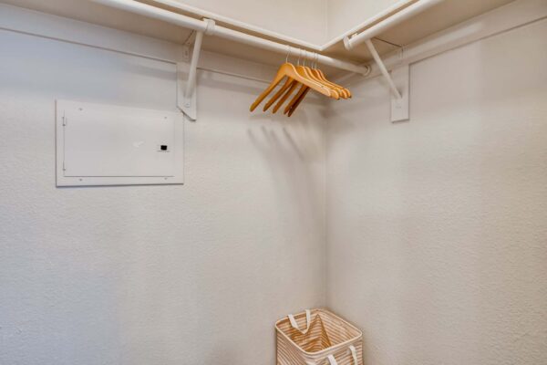 Mandarina apartment closet with built in shelves and hangers.