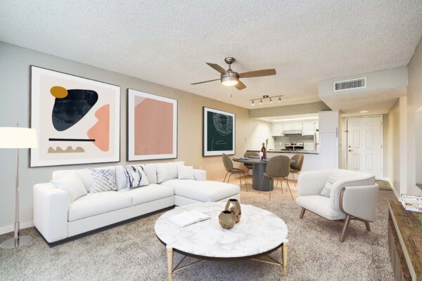 Tempe Vista apartment living room with plush seating, carpet, and large artwork.