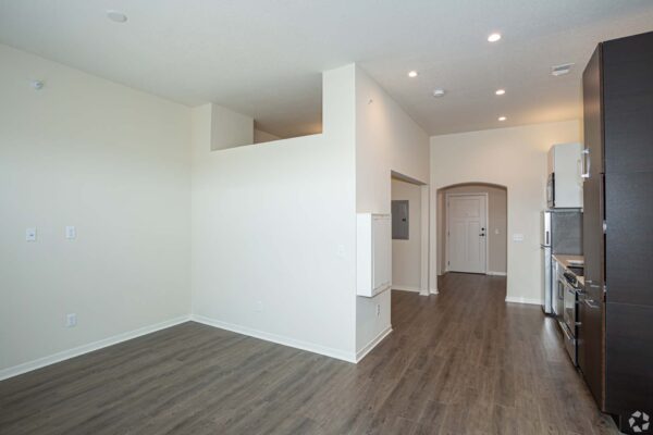The Locale apartment living area with wood style floor and modern kitchen.