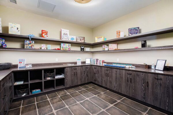 The Locale apartments craft room with gift bags, board games, and wood cabinets.