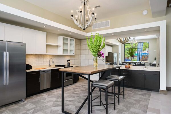 The Locale apartments community kitchen with two tone cabinets and stainless steel appliances.