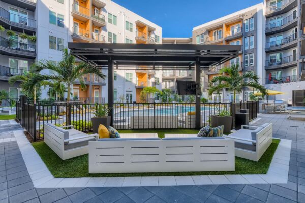 Arte St. Pete apartments pool area with plush seating and gazebo.