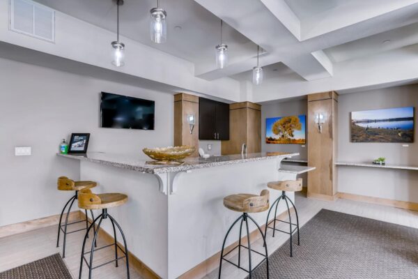 Centre Court apartments community kitchen with breakfast bar and TV.