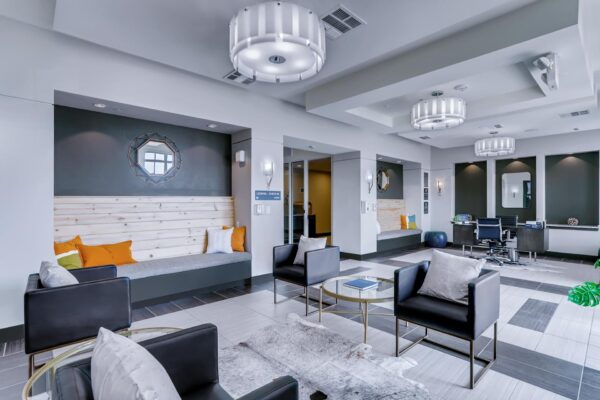 Centre Court apartments lobby with ample seating, modern light fixtures, and reception desk.