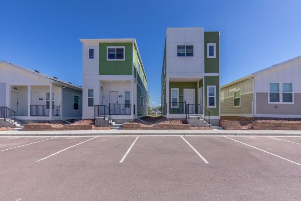 Cottages at Torin Point apartments with rocky landscaping and ample parking.