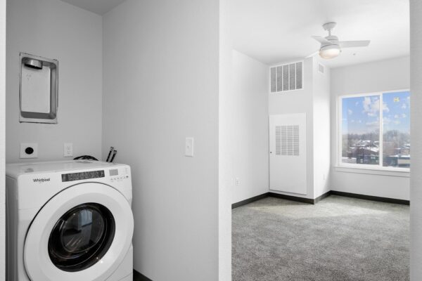 The Overland apartment laundry room with washer dryer.