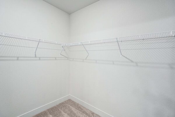 The Marc at Monument Ridge apartment closet with plush carpet and built in wire shelves.