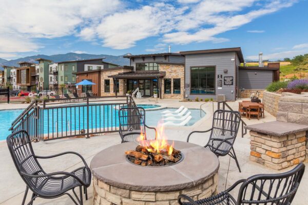 The Preserve at Mesa Creek pool area with lounge chairs and fire pit.