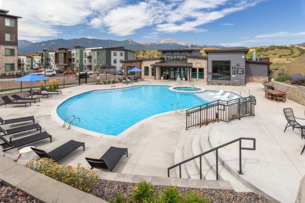 The Preserve at Mesa Creek pool area with lounge chairs and hot tub.