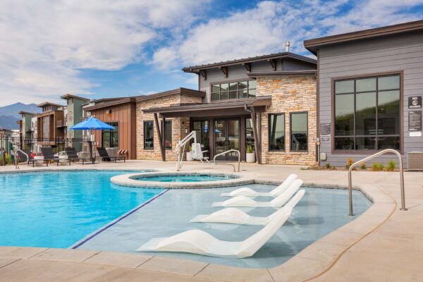 The Preserve at Mesa Creek pool area with lounge chairs and hot tub.