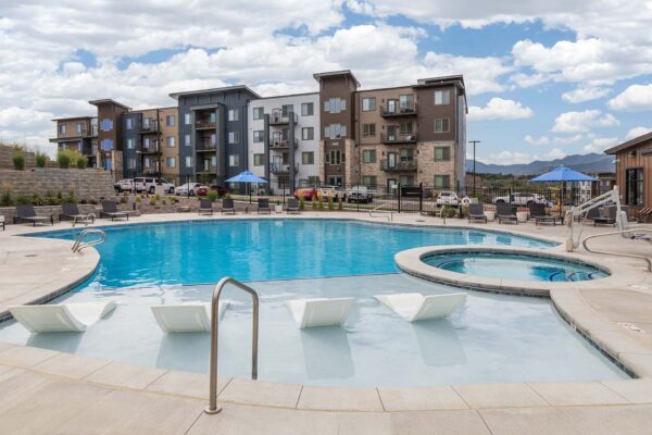 The Preserve at Mesa Creek pool area with lounge chairs and hot tub.