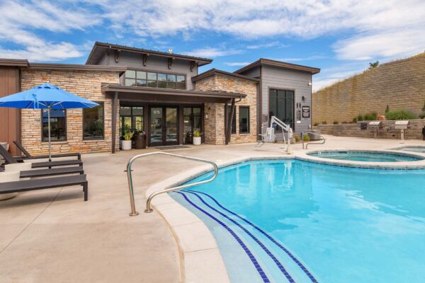 The Preserve at Mesa Creek pool area with lounge chairs and hot tub.
