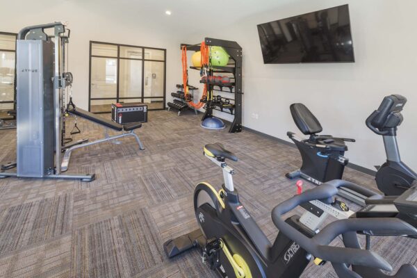 The Retreat at Patriot Park fitness center with cardio machines and weight equipment.