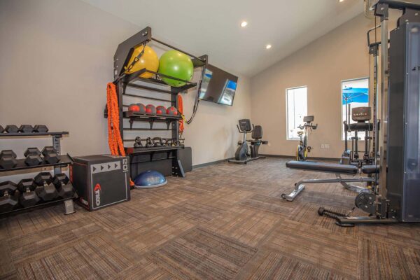 The Retreat at Patriot Park fitness center with cardio machines and weight equipment.
