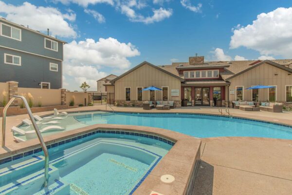 The Retreat at Patriot Park pool area with lounge chairs and hot tub.