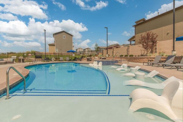 The Retreat at Patriot Park pool area with lounge chairs.