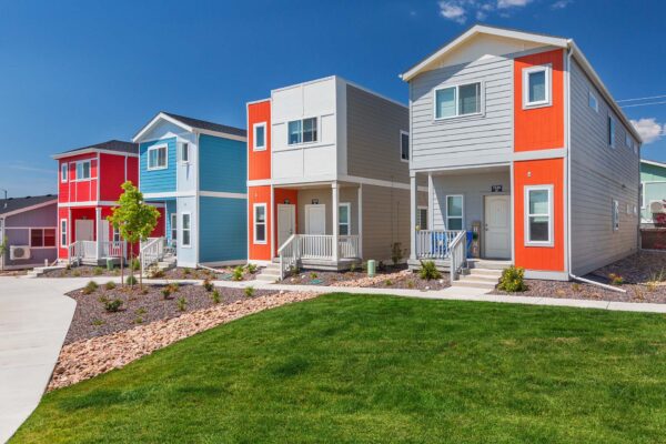 Cottages at Woodmen Heights apartment exteriors with colorful paint.