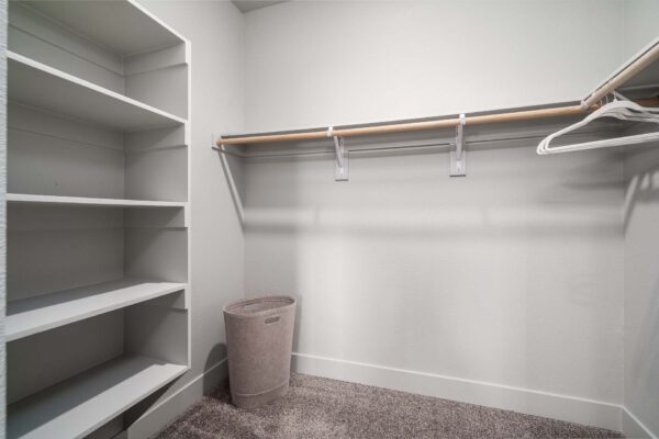 The Flats at Aero Park apartment closet with plush carpet and built in shelves.