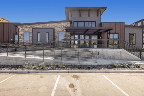 The Preserve at Mesa Creek entrance with rocky landscaping and ample parking.