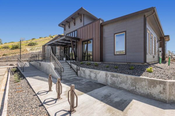 The Preserve at Mesa Creek entrance with rocky landscaping, bike rack, and modern architecture.