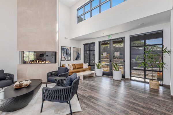 The Preserve at Mesa Creek clubhouse with large windows, ample seating, and fireplace.