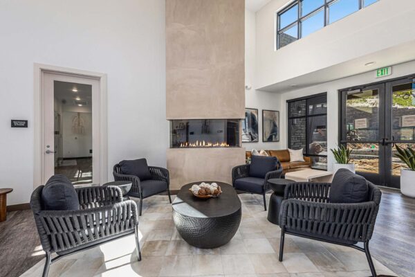 The Preserve at Mesa Creek clubroom with plush seating, fireplace, and large windows.
