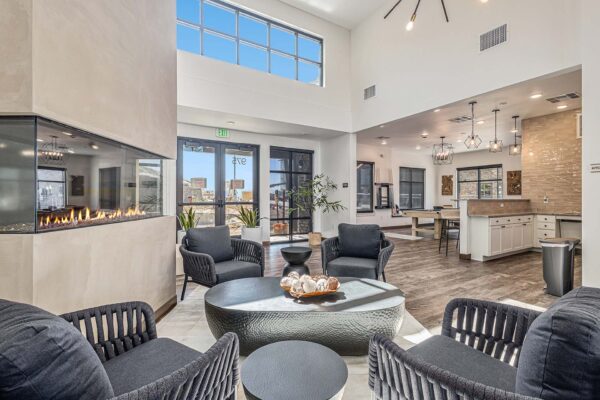 The Preserve at Mesa Creek clubroom with plush seating, fireplace, demo kitchen, and game room.