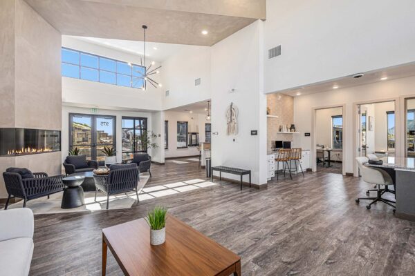 The Preserve at Mesa Creek clubroom with wood style floor, plush seating, and leasing office.