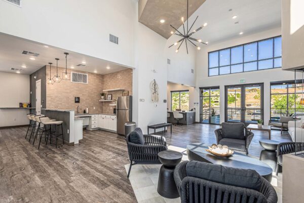 The Preserve at Mesa Creek clubroom with plush seating, vaulted ceilings, and community kitchen.
