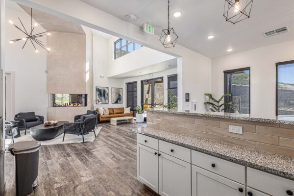 The Preserve at Mesa Creek clubroom with community bar and seating area with fireplace.