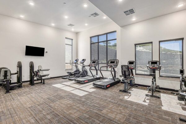 The Preserve at Mesa Creek fitness center with cardio machines and weight equipment.