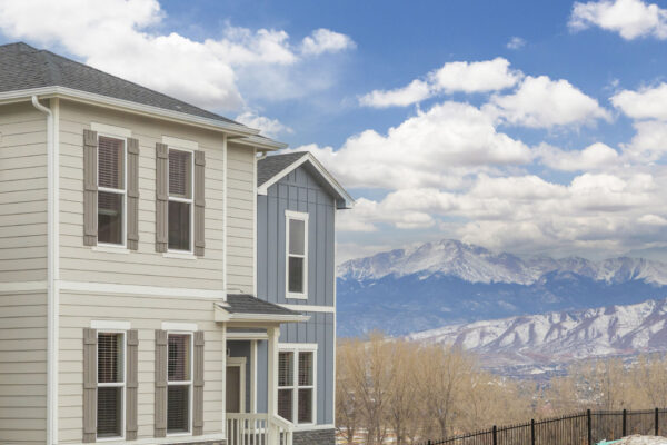 Cottages at Rampart Park apartment homes with Rocky Mountains behind.